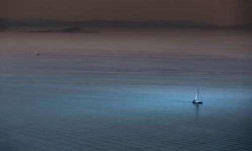 Sailboat in sea against sky
