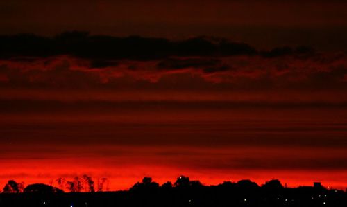 Silhouette of tree against dramatic sky