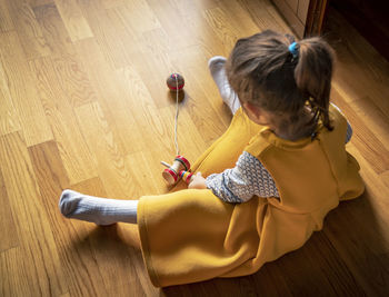 High angle view of girl holding toy at home