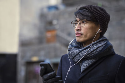 Handsome man with smartphone on street