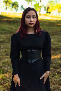 Portrait of teenager girl standing on grass