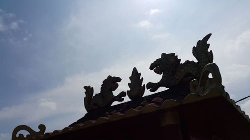 Low angle view of building against cloudy sky