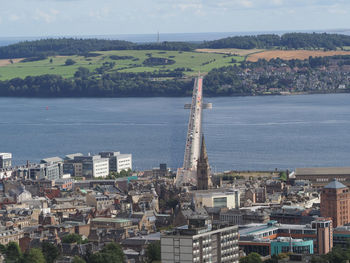 High angle view of townscape by sea against sky