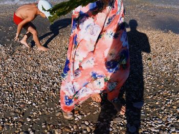 Low section of child standing on beach