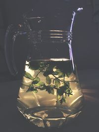 Close-up of water in jar against black background