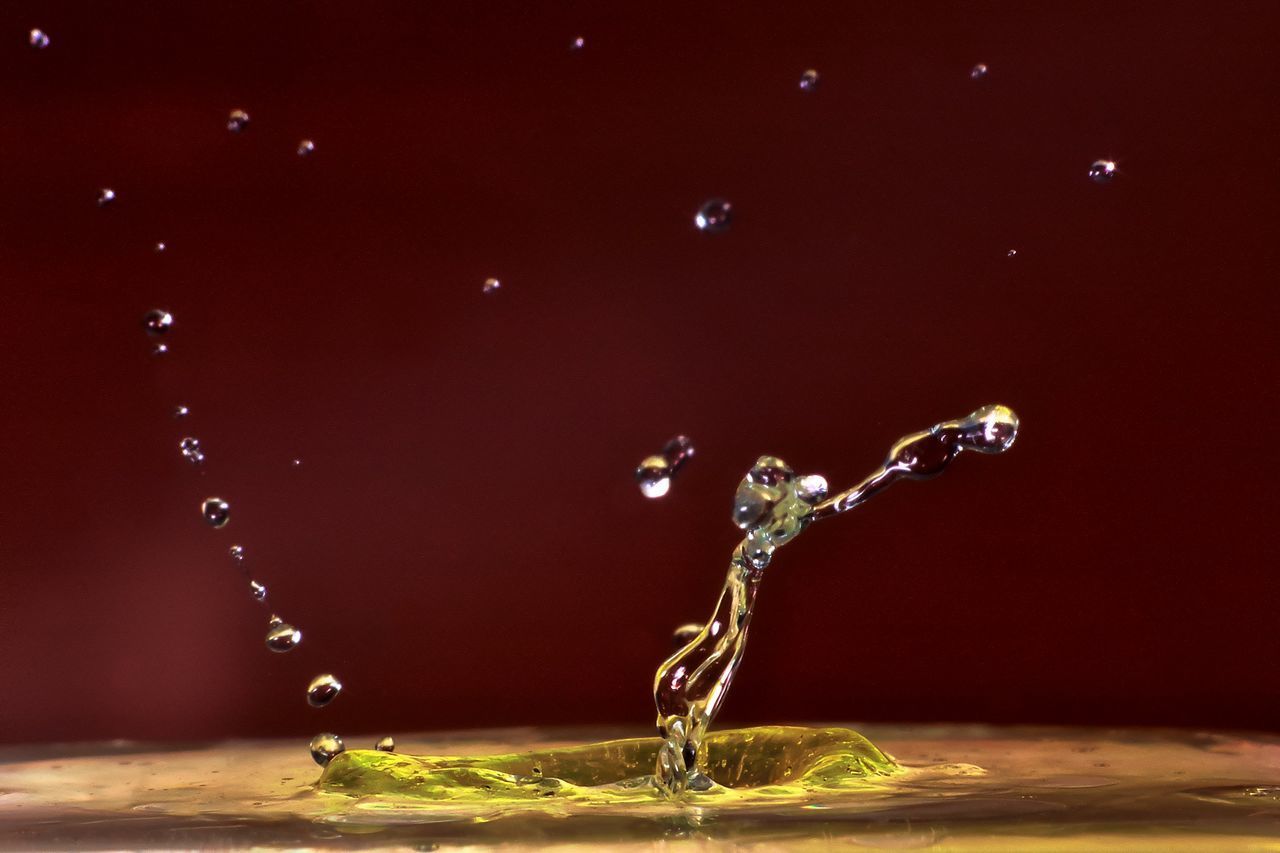 CLOSE-UP OF DROP FALLING ON RED WATER