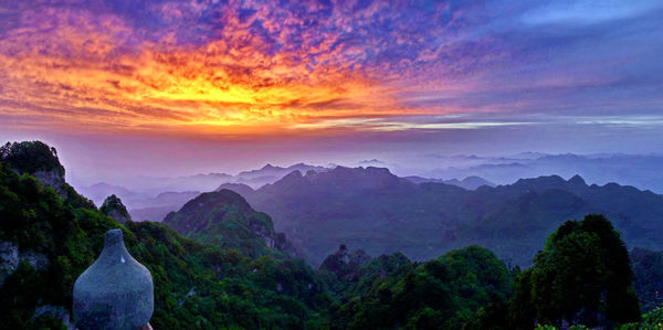 Scenic view of mountains against sky at sunset