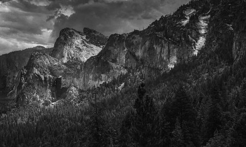 View of rocky mountains against cloudy sky