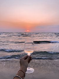 Full frame shot of beer at beach against sky during sunset