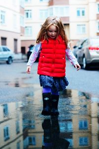 Woman on wet street in city