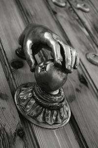 High angle view of metal sculpture on wooden door