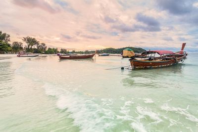 View of boats in sea at sunset