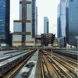 High angle view of trains on railroad track against sky in city