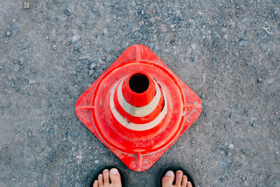 Low section of person holding red standing outdoors