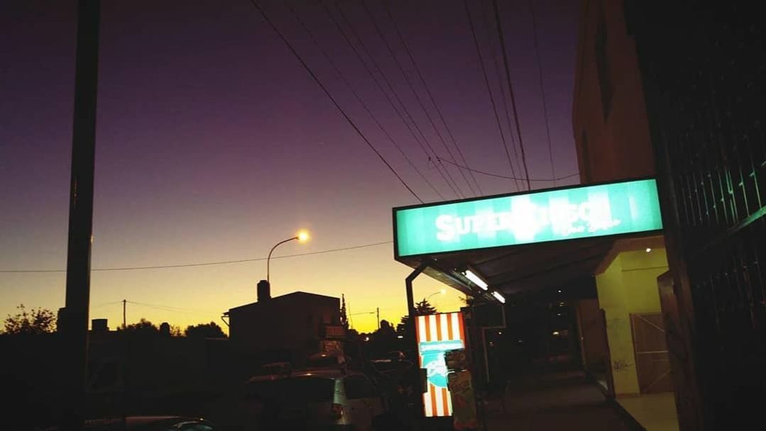 building exterior, sky, illuminated, architecture, built structure, sunset, city, electricity, night, sign, no people, street, transportation, cable, communication, silhouette, city life, road, car, nature, light, outdoors