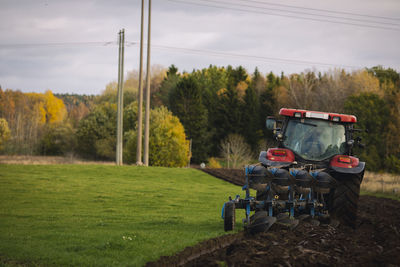 Tractor plowing field at autumn