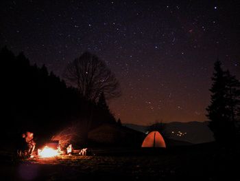 Tent on field against sky at night