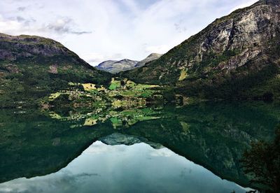 Scenic view of lake and mountains against sky