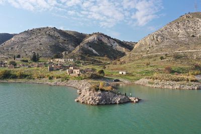 Scenic view of lake and mountains against sky