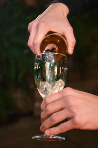 Close-up of person holding glass of water