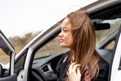 View of young woman sitting in car
