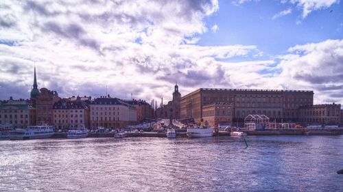 Boat in river with buildings in background