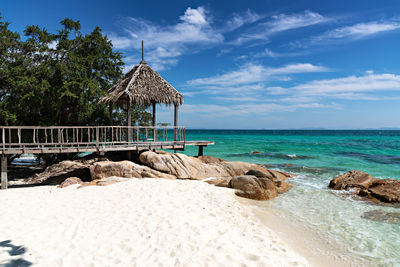 Built structure on beach against sky