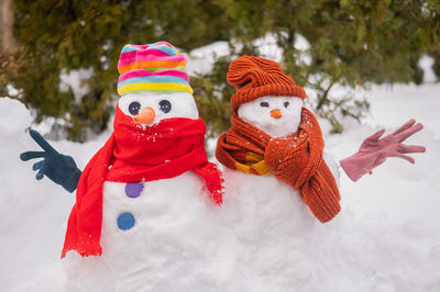 Snowman on snow covered field