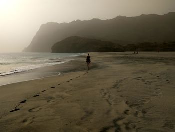 Man on beach against sky