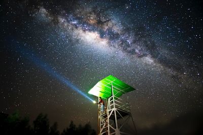 Low angle view of illuminated tree against sky at night