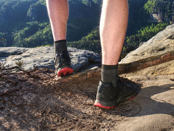 Young man strong legs off trail running at amazing summer sunset in sport and healthy lifestyle