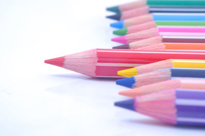 Close-up of colorful pencils over white background