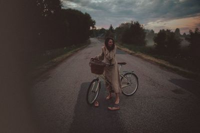 Portrait of women riding bicycle on road