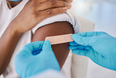 Midsection of doctor examining patient in hospital