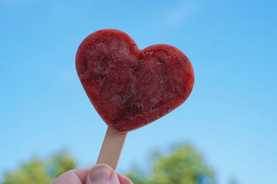 Midsection of person holding heart shape