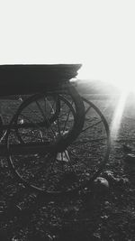 Tilt image of bicycle on field against sky