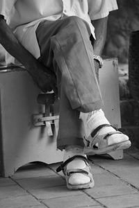 Low section of person sitting on chair