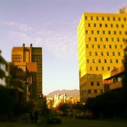 Low angle view of buildings against sky at sunset