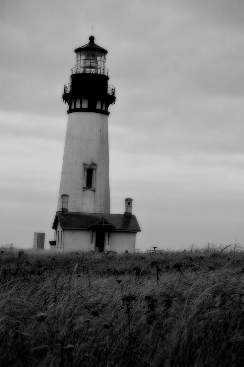 lighthouse, building exterior, architecture, built structure, sky, guidance, cloud - sky, field, protection, safety, security, direction, landscape, tower, rural scene, nature, cloudy, cloud, tranquil scene, tranquility