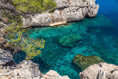 High angle view of rocks by sea