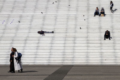 People walking on wall