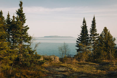 Scenic view of sea and mountains against sky