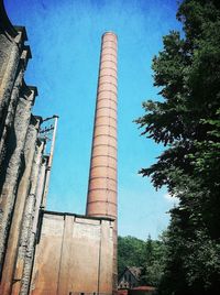 Low angle view of tower against blue sky