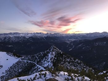 Scenic view of snowcapped mountains against sky during sunset