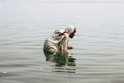 High angle view of man working in lake