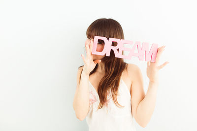 Midsection of young woman against white background