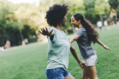 Two best friends having fun together in the park at evening