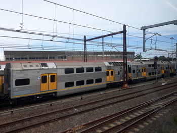 Train on railroad tracks against sky. this is sydney train service of australia.