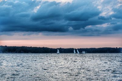 Scenic view of calm sea against cloudy sky