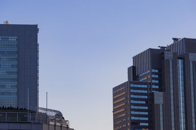 Low angle view of buildings against clear blue sky